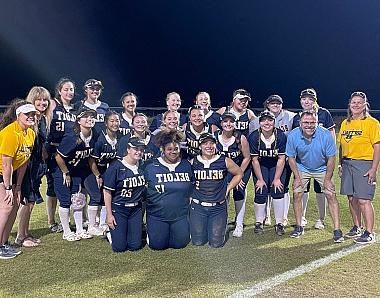 President Eric Boynton and his wife, Julie, posed in a group photo with the Buccaneer Softball team.