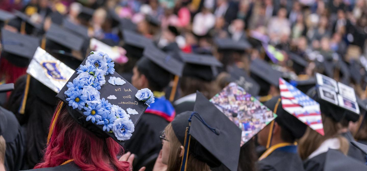Students in decorated caps during Commencement.